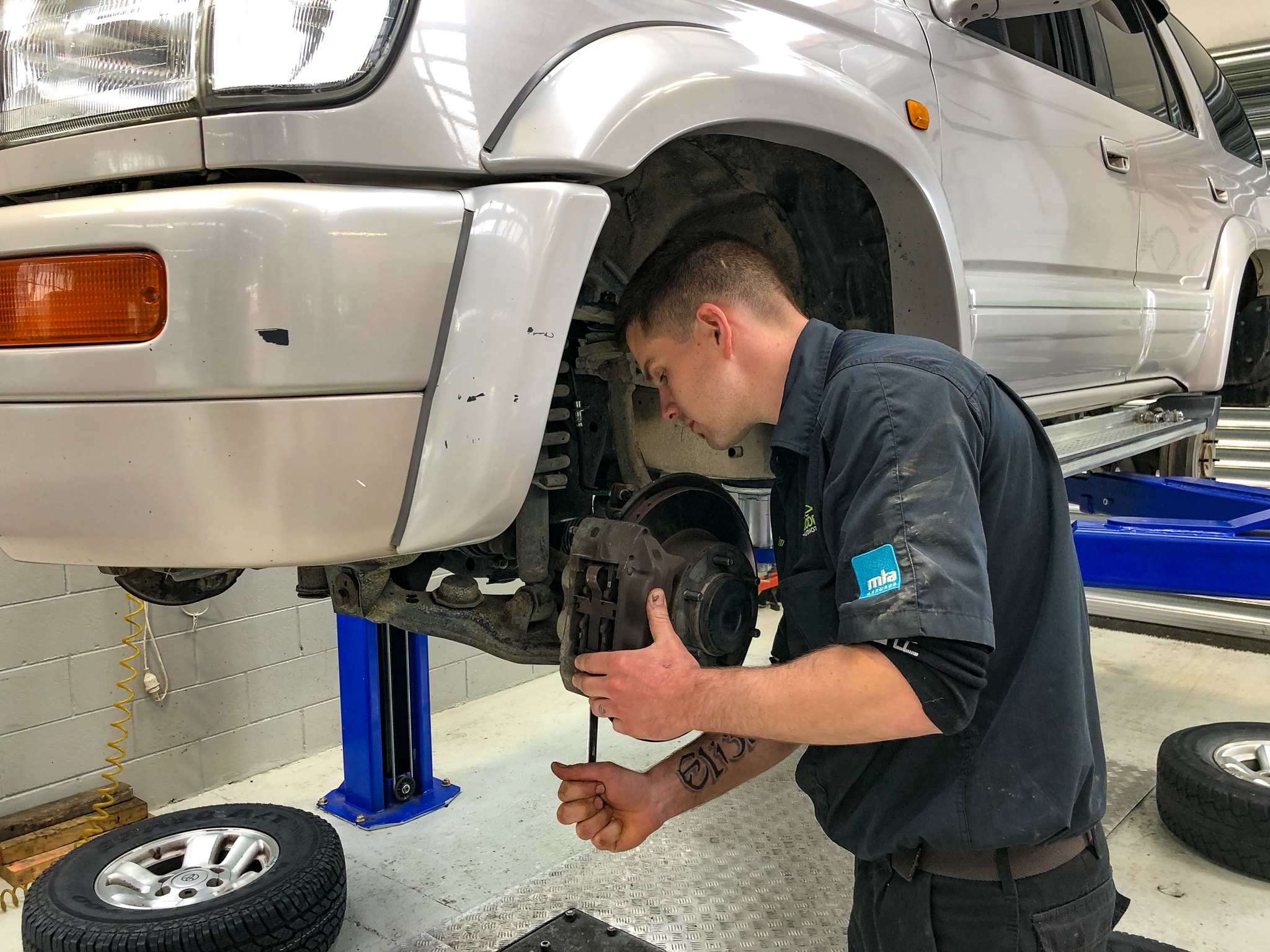 One of our experienced mechanics doing a brake repair on a vehicle in Woodend